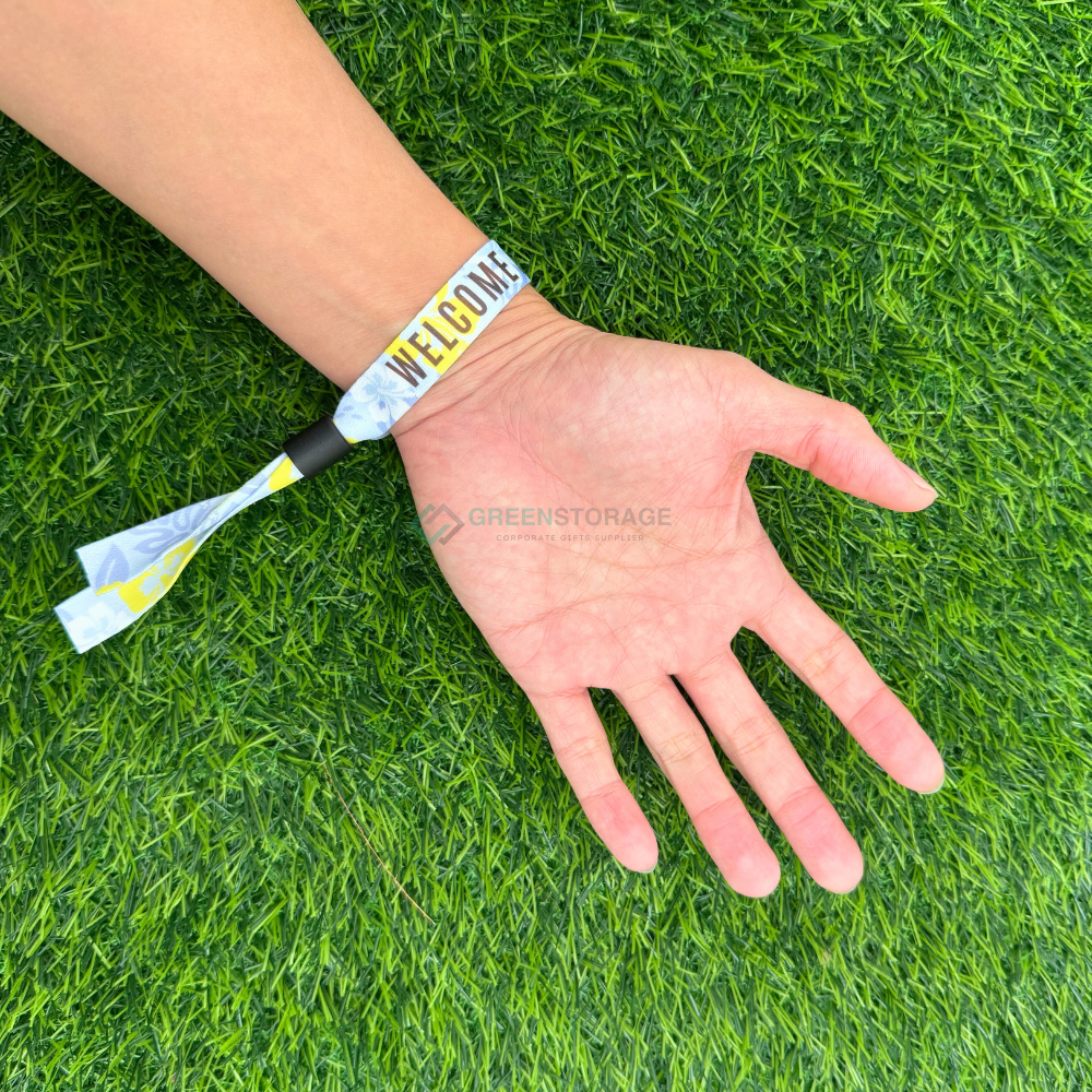 Colorful festival cloth wristbands on hands for music event access control